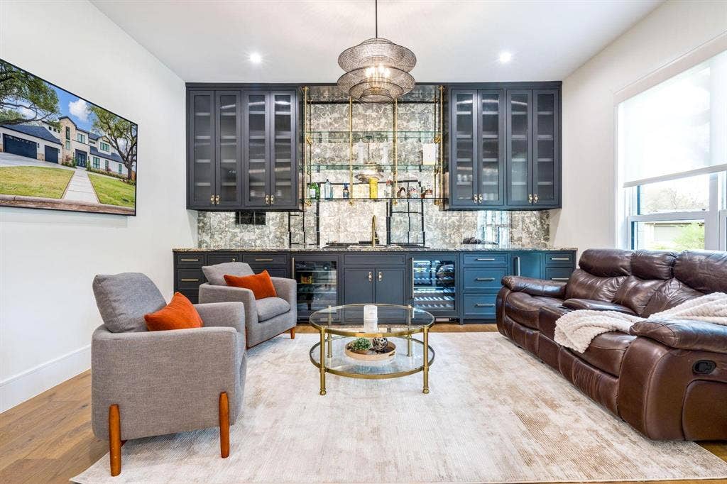 12007 Quincy Lane, Dallas, TX 75230 Built-in wet bar with dark cabinetry, glass-front upper cabinets, and integrated beverage refrigerators
