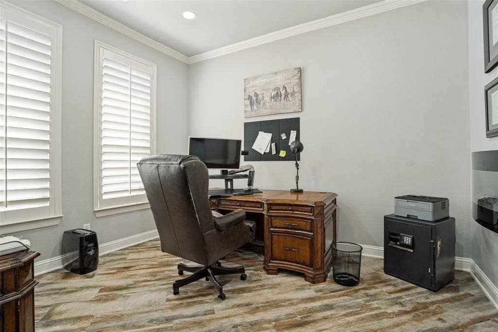 1250 Packsaddle Trail, Prosper, TX 75078 Light-toned walls with crown molding, two windows with white plantation shutters, and wood-finish flooring