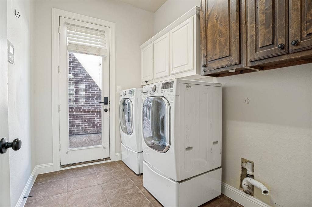 1250 Packsaddle Trail, Prosper, TX 75078 Laundry area featuring tile flooring, white upper cabinetry, and dark wood-finish upper cabinetry