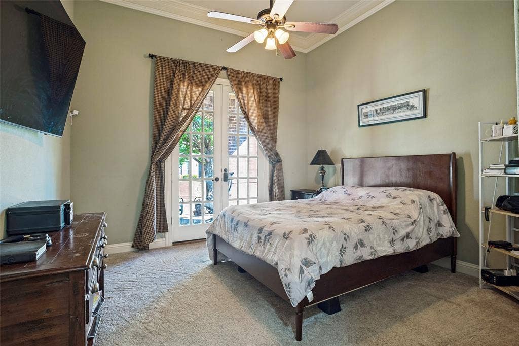 1250 Packsaddle Trail, Prosper, TX 75078 Double French doors, crown molding, wall-mounted television, and carpet flooring