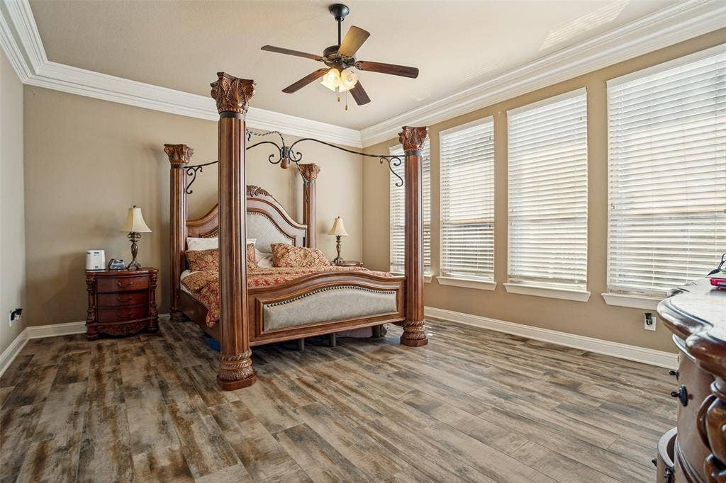1250 Packsaddle Trail, Prosper, TX 75078 Wood-finish flooring, crown molding, ceiling fan, and multiple windows with blinds