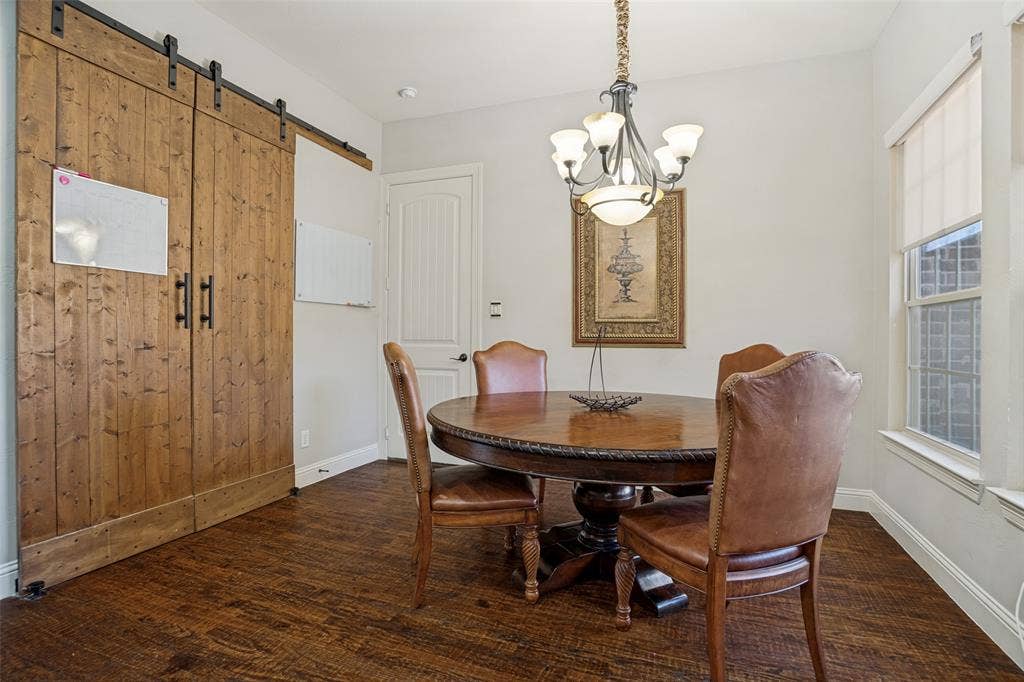 1250 Packsaddle Trail, Prosper, TX 75078 Wood-finish flooring, white walls, and a large window with roller shades