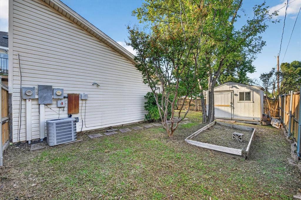 The backyard features a small deck for outdoor enjoyment and a convenient storage shed for tools, equipment, and extra belongings