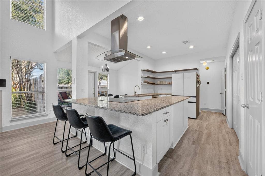 The convenient breakfast bar offers additional seating and a perfect spot for casual dining, morning coffee, or gathering with guests