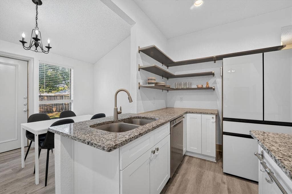 The breakfast bar creates a welcoming gathering spot, perfect for quick meals, conversation, and entertaining while staying connected to the kitchen