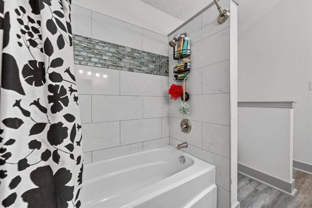 Large primary bathroom with dual vanities and large tub