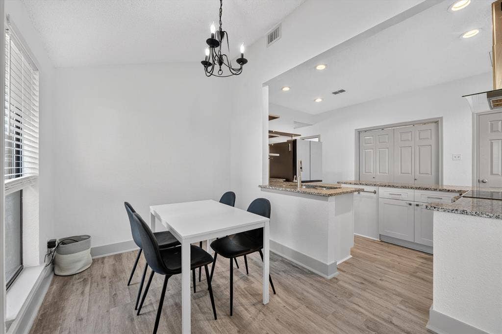 The dining room offers an open, airy feel with an easy connection to the kitchen, making mealtime and entertaining effortless