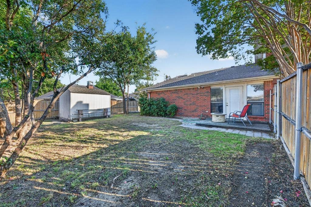 The backyard features a charming deck, offering a cozy outdoor space to relax, enjoy your morning coffee, or unwind in the fresh air.