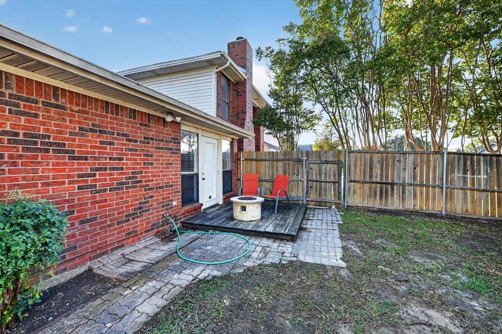 The backyard features a charming deck, offering a cozy outdoor space to relax, enjoy your morning coffee, or unwind in the fresh air.