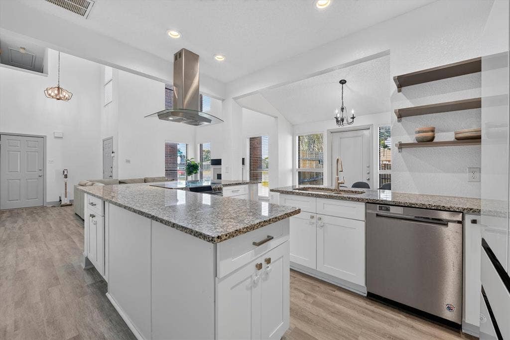 The kitchen falso features a dishwsher, disposal, and open shelving that creates a modern feel while adding extra storage.