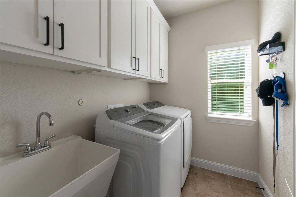 2901 Regents Park Lane, Garland, TX 75043 Laundry room with sink and cabinets, plenty of storage