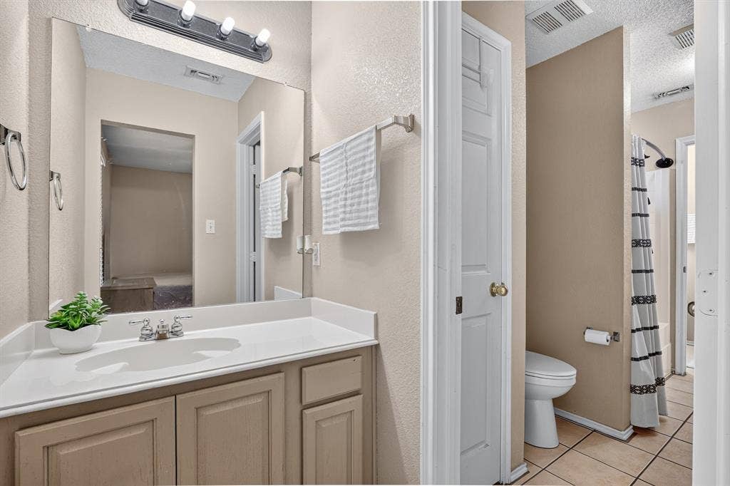 Vanity with an integrated sink, polished chrome faucet, and under-sink cabinetry