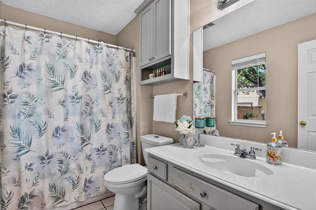 Vanity with integrated sink, chrome faucet, and lower cabinetry