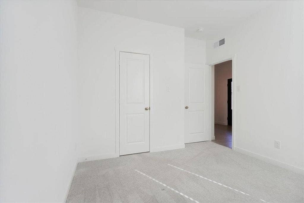Light gray carpeting and white walls with white trim