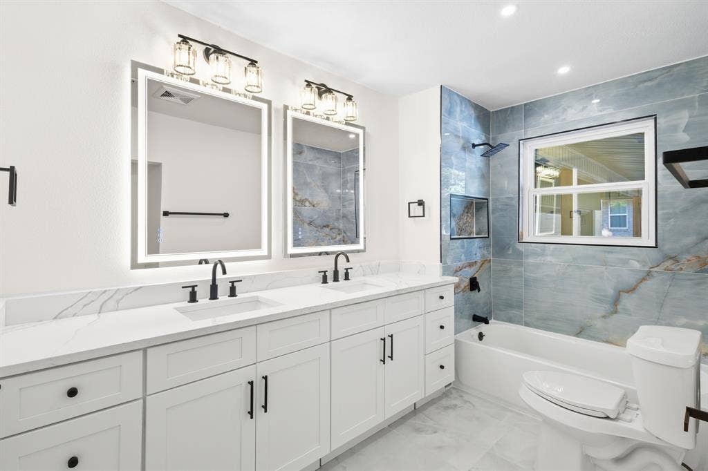 917 Blossom Circle, Garland, TX 75041 WOW effect, brilliant blend of high-end blue tiles and white quartz countertops with white cabinetry
