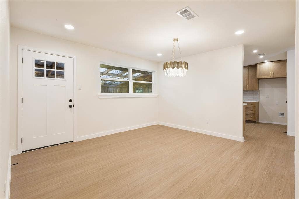 917 Blossom Circle, Garland, TX 75041 Dining room with can ceiling lighting, flush-panel door with window inserts, and a decorative chandelier
