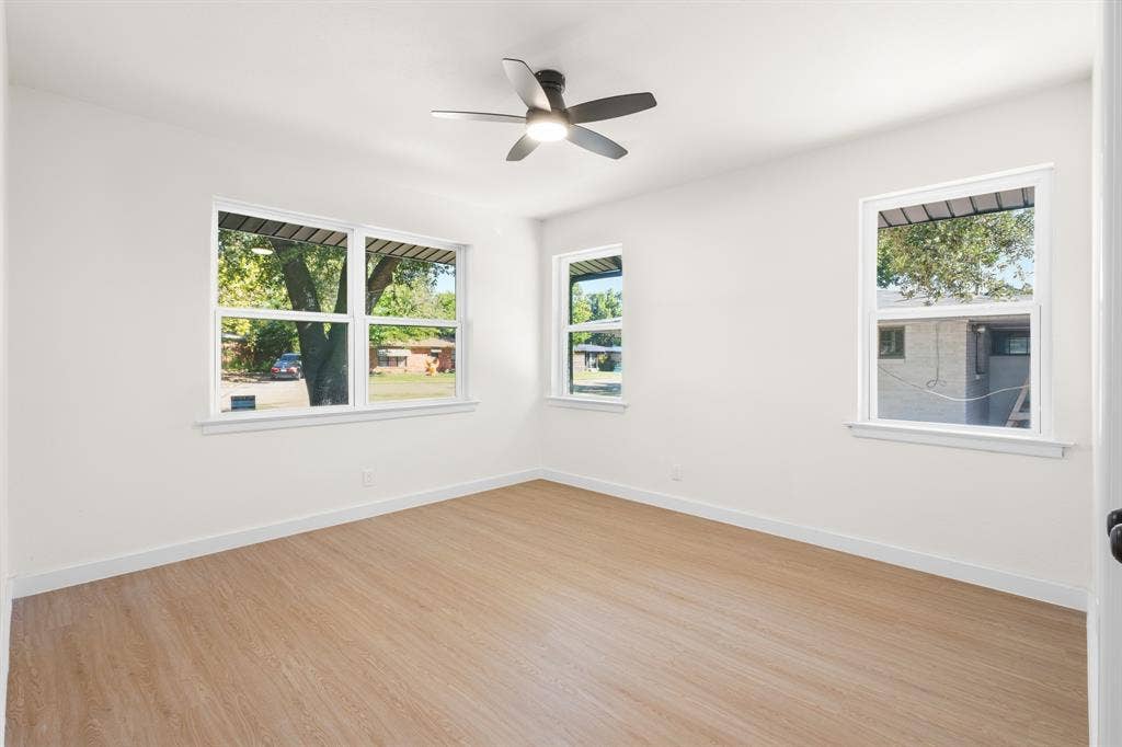 917 Blossom Circle, Garland, TX 75041 Bedroom with brand new windows, new ceiling fan and walk in closet