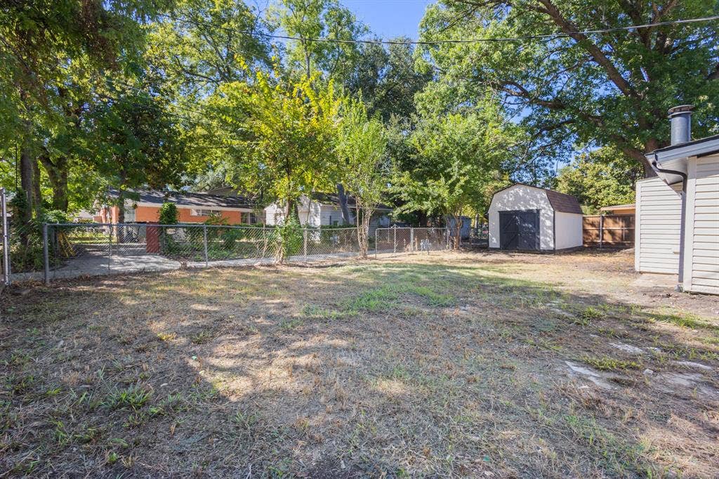 917 Blossom Circle, Garland, TX 75041 Expansive yard with fenced perimeter, and a detached storage shed