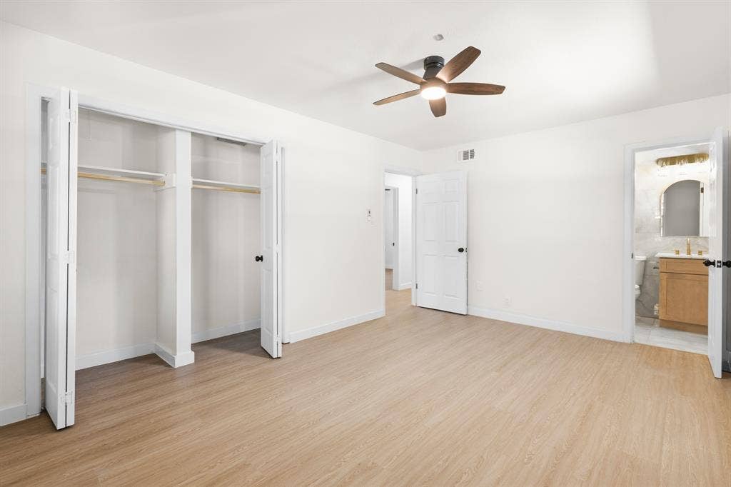 917 Blossom Circle, Garland, TX 75041 Master bedroom with ceiling fan with light, bi-fold closet doors, highly upgraded attached bathroom