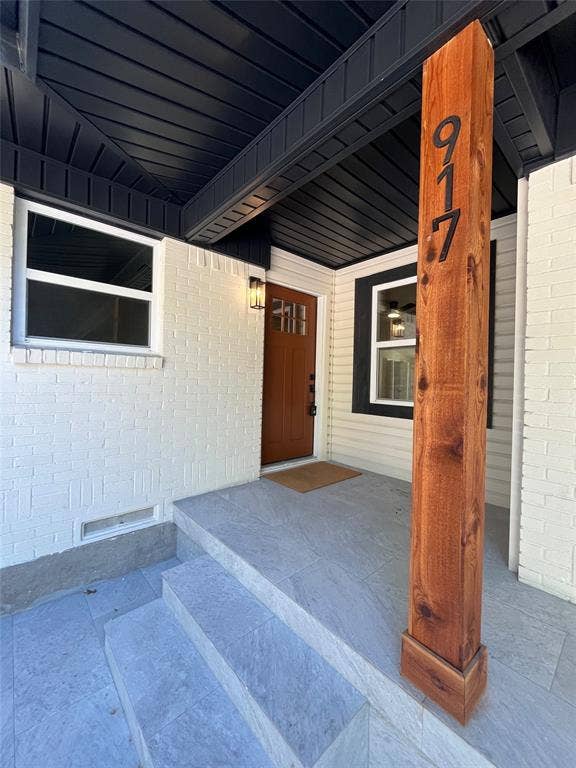 917 Blossom Circle, Garland, TX 75041 Brick and siding exterior with a wood-finish entry door