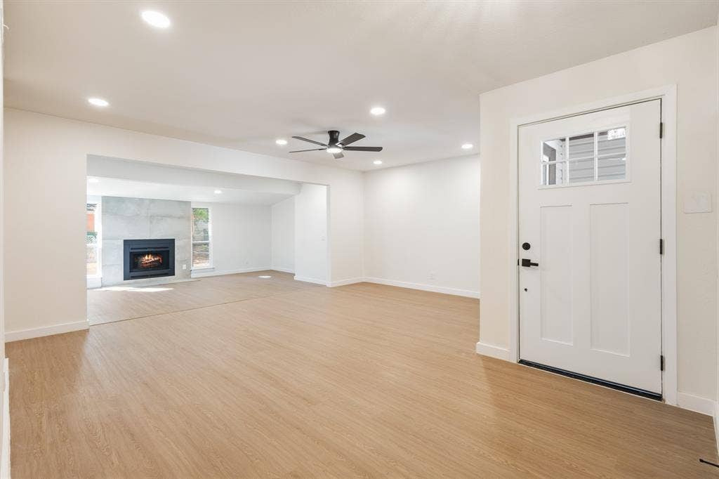 917 Blossom Circle, Garland, TX 75041 Living room and family room with durable Water & scratch proof flooring, can lighting throughout, modern ceiling fan