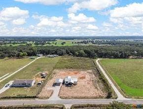 Expansive rural property featuring a main structure, a detached garage, and an additional outbuilding