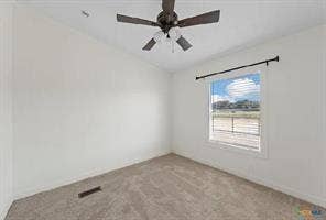 Carpeted flooring, white painted walls, a ceiling fan, and a window with horizontal blinds