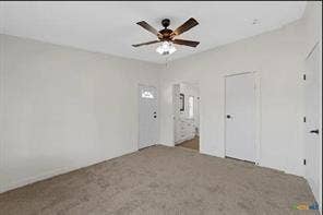 Carpeted flooring, white walls, and a ceiling fan with integrated lighting