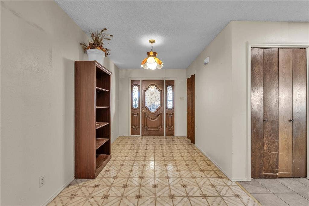 4201 N 19th Street, Waco, TX 76708 Patterned tile flooring, wood-paneled entry doors with decorative glass inserts, and a ceiling-mounted light fixture