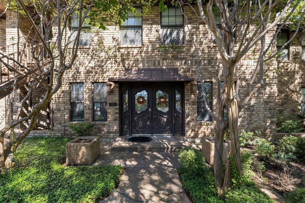 4201 N 19th Street, Waco, TX 76708 Brick facade with multiple windows, a covered double entry door, and concrete walkways