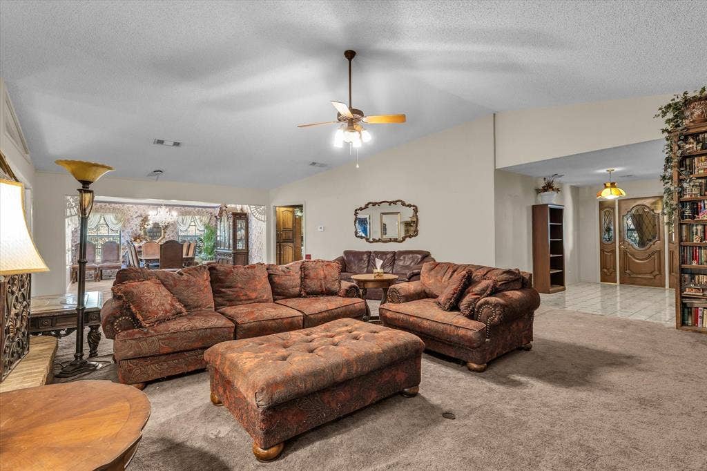 4201 N 19th Street, Waco, TX 76708 Carpeted living area with a vaulted ceiling, ceiling fan, and recessed lighting