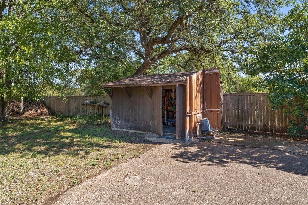 4201 N 19th Street, Waco, TX 76708 Outdoor storage shed with a shingle roof and wood siding