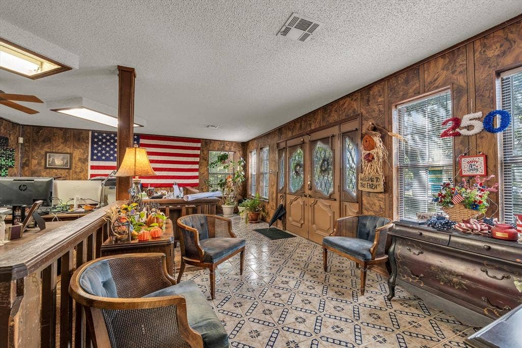 4201 N 19th Street, Waco, TX 76708 Patterned tile flooring, wood paneling, recessed lighting, ceiling fan, and French-style doors with decorative glass inserts
