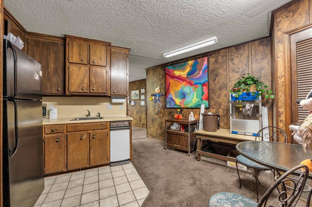 4201 N 19th Street, Waco, TX 76708 Kitchen featuring wood cabinetry, a stainless steel refrigerator, a white dishwasher, and tiled flooring