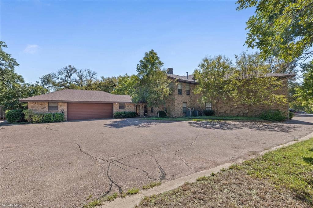 4201 N 19th Street, Waco, TX 76708 Brick exterior construction with a brown garage door