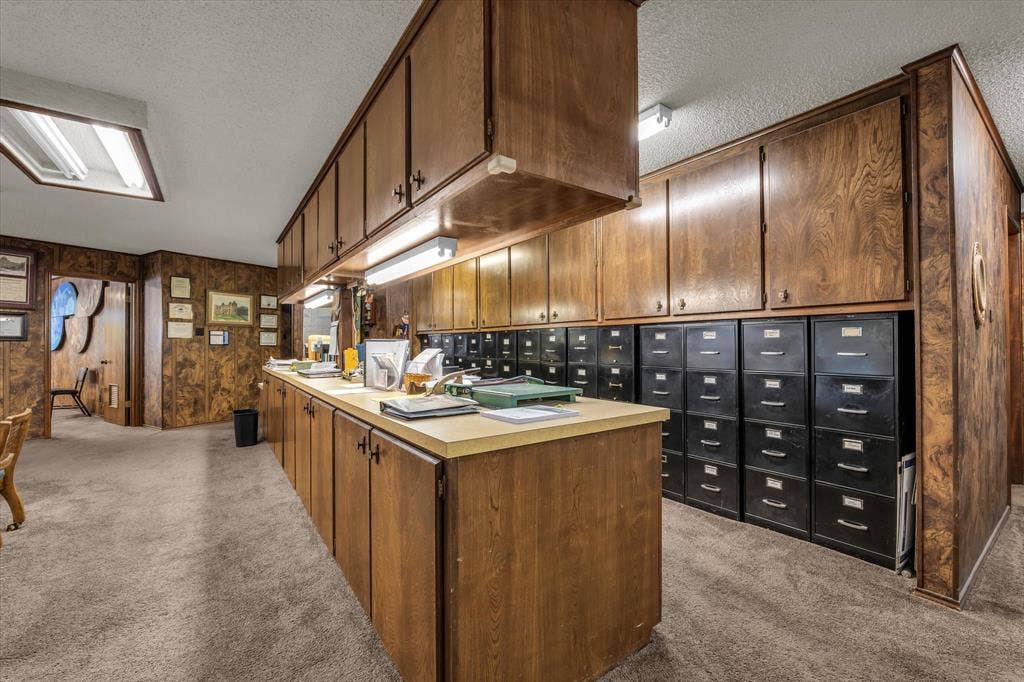 4201 N 19th Street, Waco, TX 76708 Extensive wood-finish cabinetry, integrated under-cabinet lighting, light-toned countertop, and recessed ceiling lighting