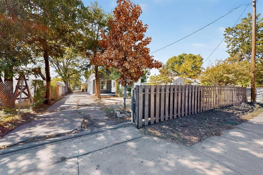 651 Ezekial Avenue, Dallas, TX 75217 Paved driveway leading to a residence with exterior siding and a front porch