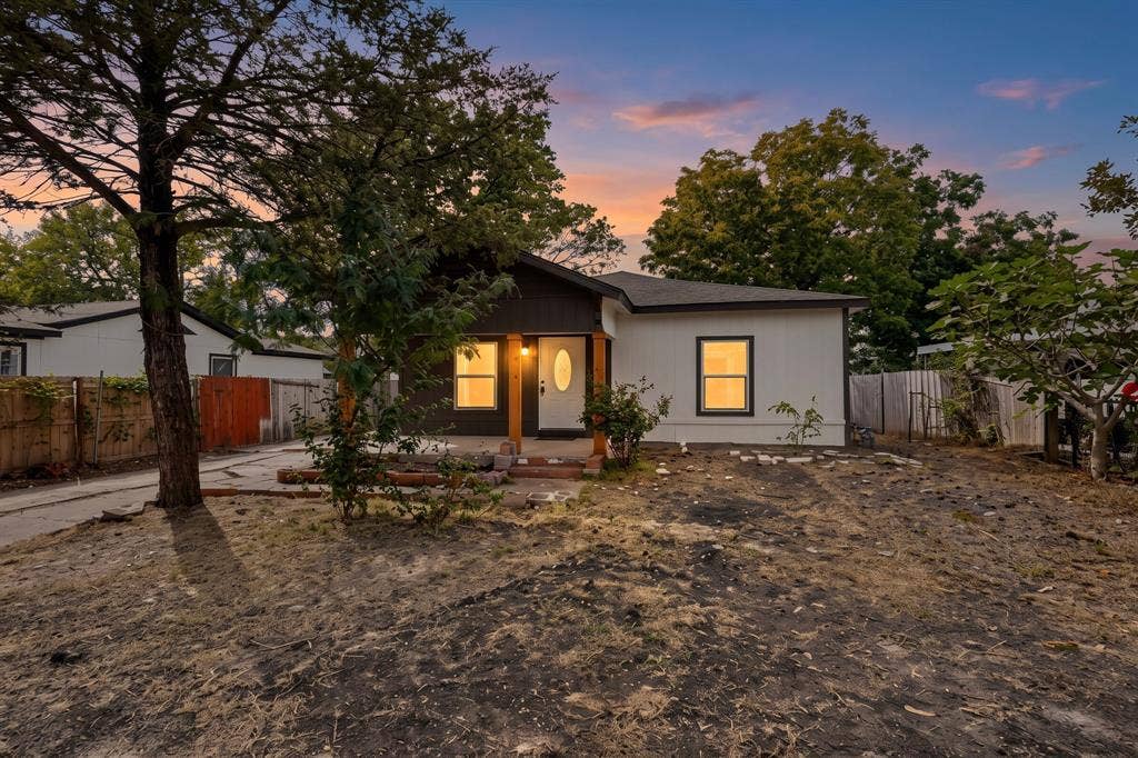 651 Ezekial Avenue, Dallas, TX 75217 Modern single-story residence with clean-lined architecture and a bright, open facade featuring multiple windows that flood the interior with natural light
