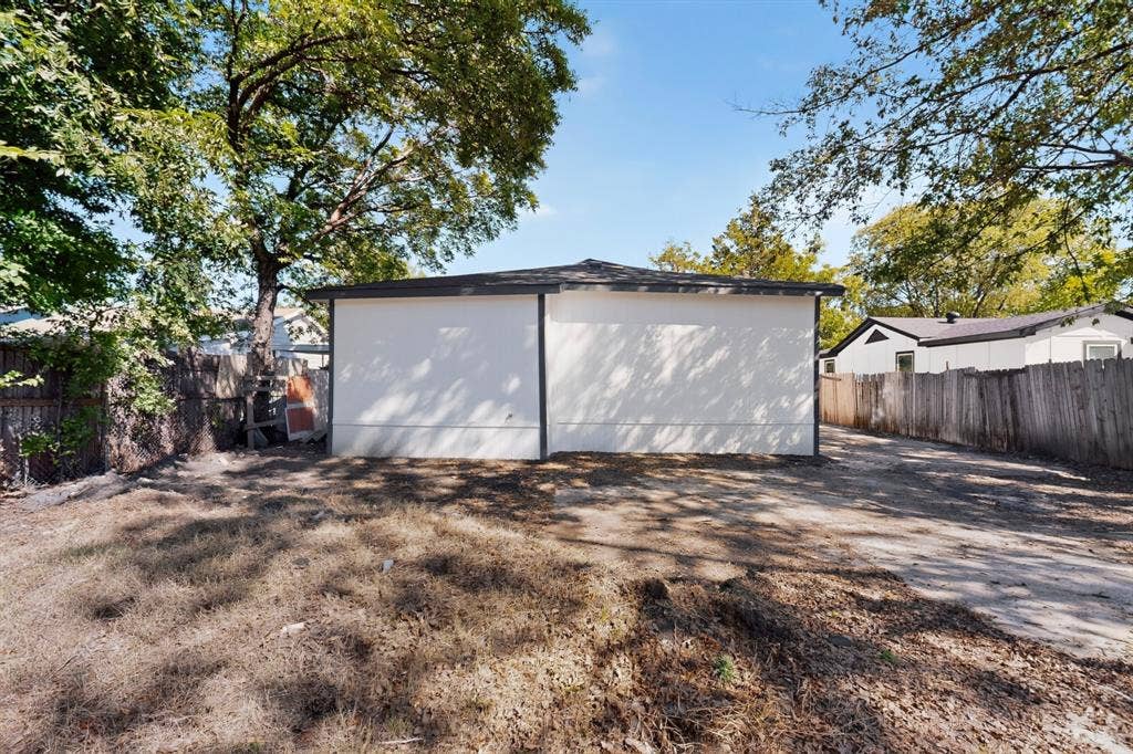 651 Ezekial Avenue, Dallas, TX 75217 White stucco exterior with a dark trim roofline