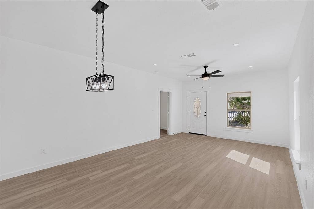 651 Ezekial Avenue, Dallas, TX 75217 Light wood-finish flooring, white walls, and recessed lighting