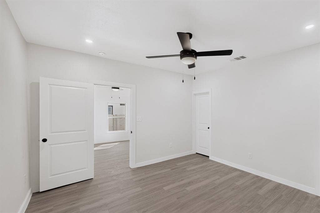 651 Ezekial Avenue, Dallas, TX 75217 Wood-finish flooring, recessed lighting, and a contemporary ceiling fan with integrated lighting