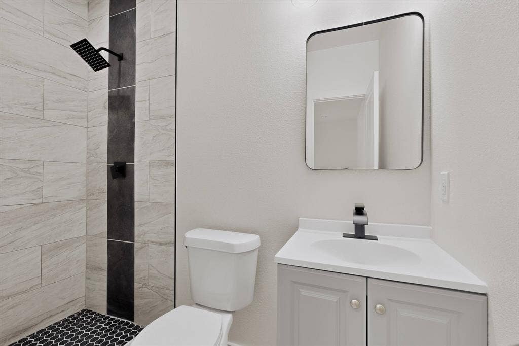 651 Ezekial Avenue, Dallas, TX 75217 White vanity with an integrated sink and matte black faucet