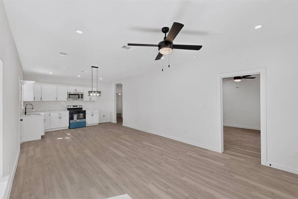 651 Ezekial Avenue, Dallas, TX 75217 Open-concept living area with wood-finish flooring, recessed lighting, and a contemporary ceiling fan