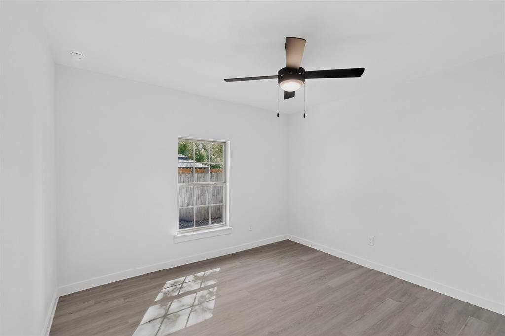 651 Ezekial Avenue, Dallas, TX 75217 Recessed ceiling light, wood-finish flooring, white walls, double-hung window, and ceiling fan with integrated light fixture