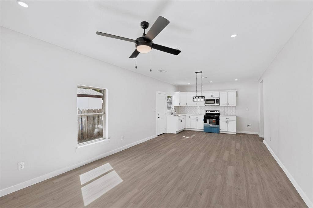 651 Ezekial Avenue, Dallas, TX 75217 Spacious room with wood-finish flooring, recessed lighting, and a modern ceiling fan