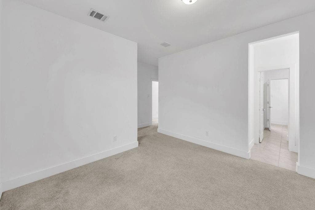 8300 Bethpage Drive, McKinney, TX 75070 Light-toned carpeting, crisp white walls, and a recessed ceiling light fixture