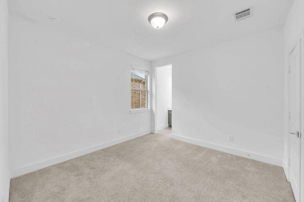8300 Bethpage Drive, McKinney, TX 75070 Light gray wall-to-wall carpeting, single window with white trim, flush mount ceiling light fixture, white interior door with polished nickel hardware, and an open doorway