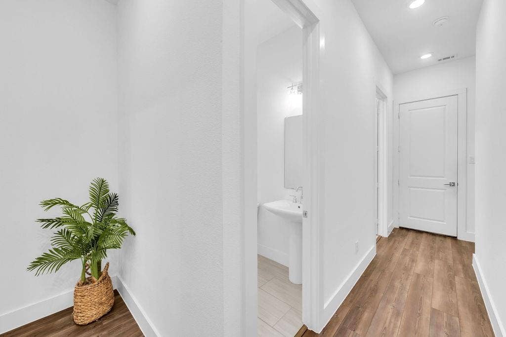 8300 Bethpage Drive, McKinney, TX 75070 Hallway with wood-finish flooring, recessed lighting, and a white interior door