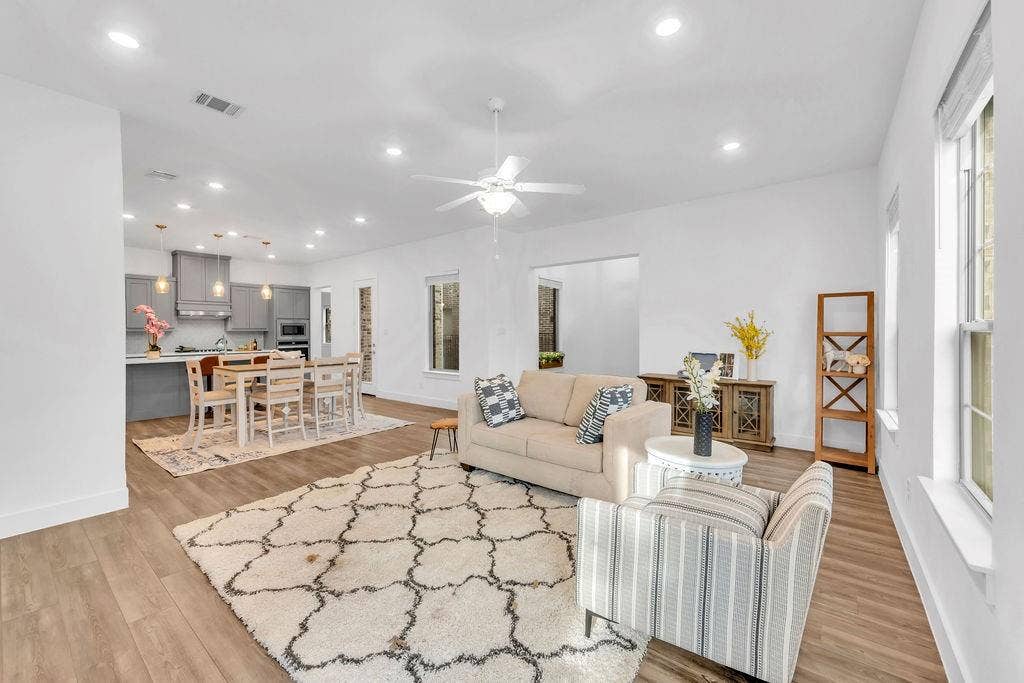8300 Bethpage Drive, McKinney, TX 75070 Open-concept living space featuring wood-finish flooring, recessed lighting, and a ceiling fan