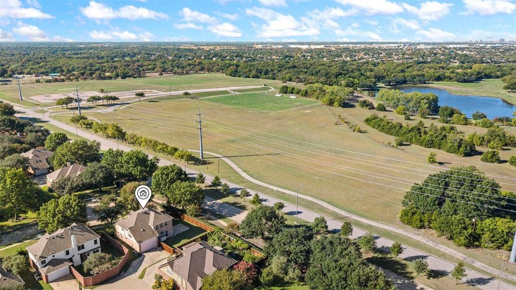 5401 Wolcott Place, Richardson, TX 75082 Aerial perspective showcasing surrounding natural landscape, expansive open fields, and a body of water